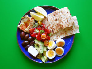 East Van Kitchen's Rustic Breakfast is a hearty + colourful way to start the day! Boiled eggs, bruschetta, avocado, toasted flatbread, hummus, olives + feta with a squeeze of lemon