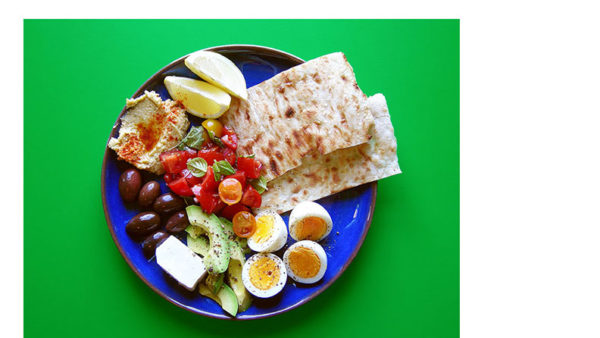 East Van Kitchen's Rustic Breakfast is a hearty + colourful way to start the day! Boiled eggs, bruschetta, avocado, toasted flatbread, hummus, olives + feta with a squeeze of lemon