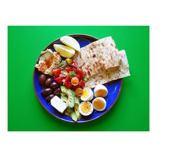 East Van Kitchen's Rustic Breakfast is a hearty + colourful way to start the day! Boiled eggs, bruschetta, avocado, toasted flatbread, hummus, olives + feta with a squeeze of lemon